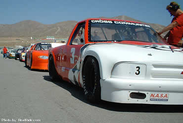 Race Cars and Race Trucks Line Up On the Grid For The Race Start