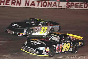 # 99 Denny Hamlin makes pass on # 27 Lee Tissot  coming off corner #2.